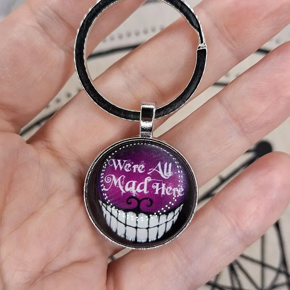 Cheshire cat we are all mad glow in the dark keychain